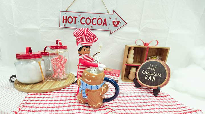 elf on the shelf making hot cocoa in a cocoa station